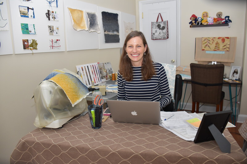 Laura Sapelly at her desk in her studio