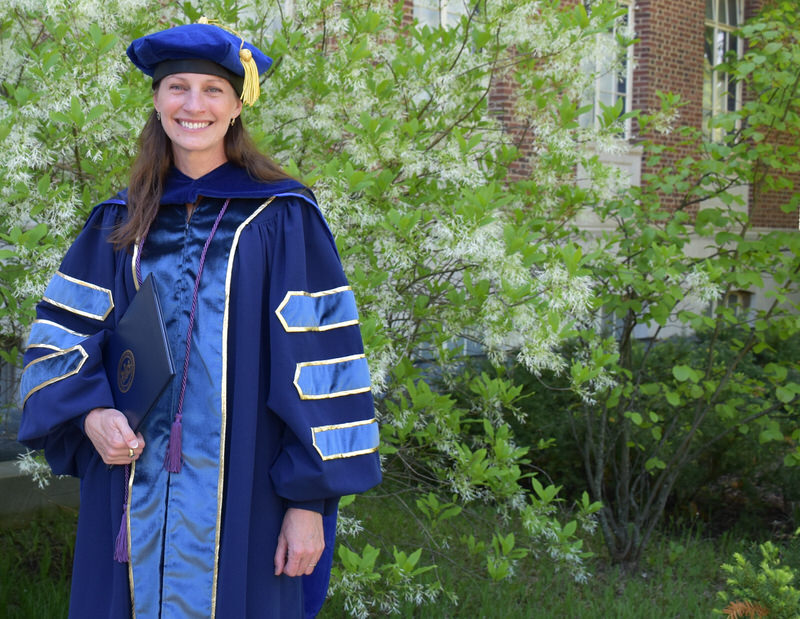 Laura Sapelly in Doctoral Graduation Regalia, Penn State campus