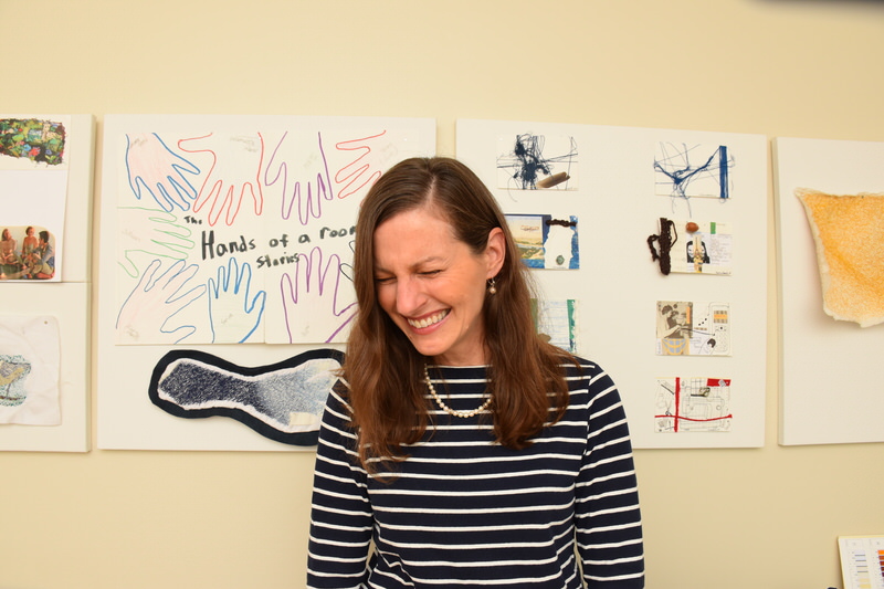 Laura Sapelly laughing in her studio